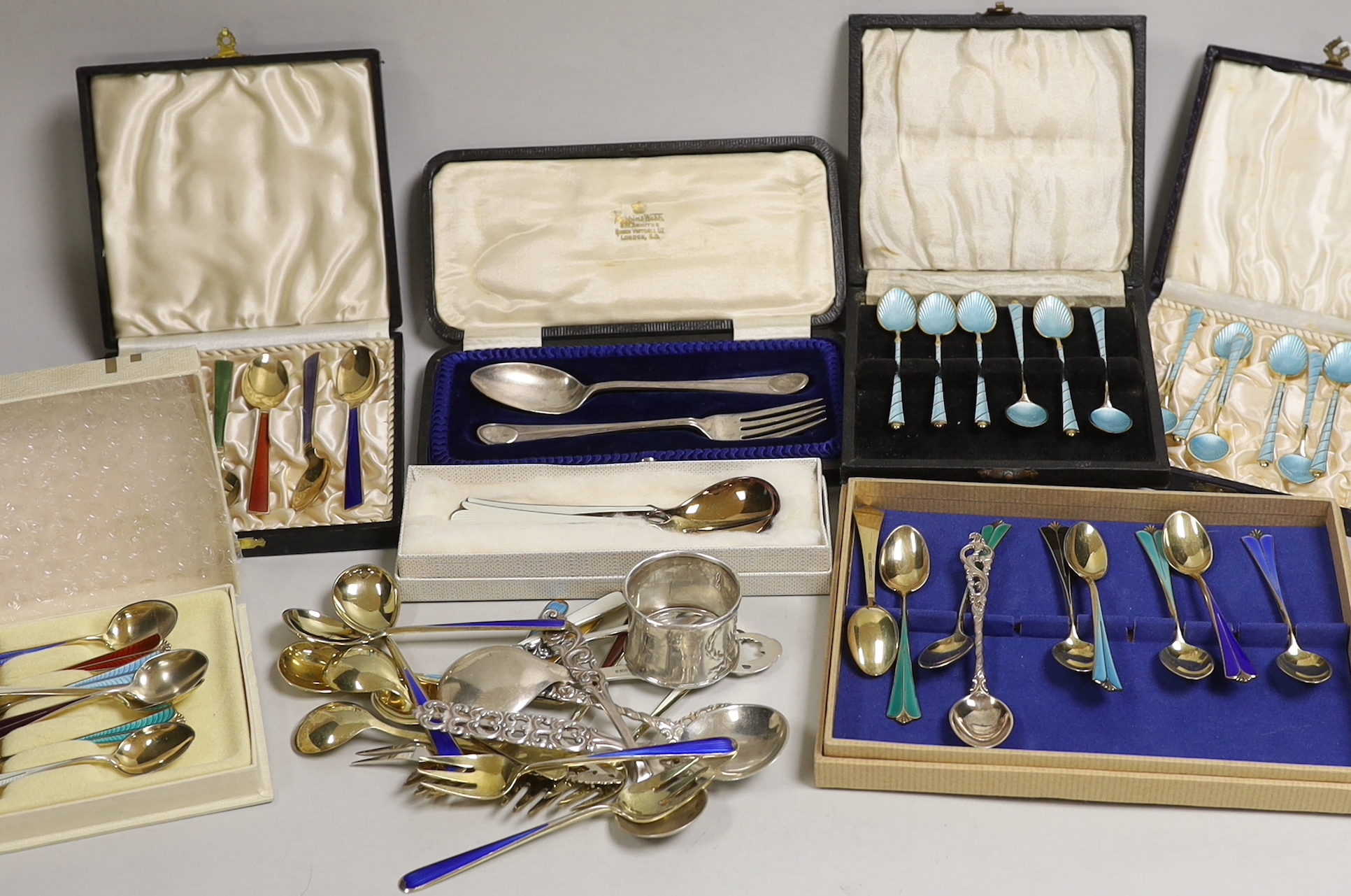 Two sets of eight Norwegian 925S and polychrome enamelled coffee spoons, by David Andersen, one other cased set of six Norwegian 925 and enamelled coffee spoons, a similar spoon and fork, a set of twelve Danish sterling